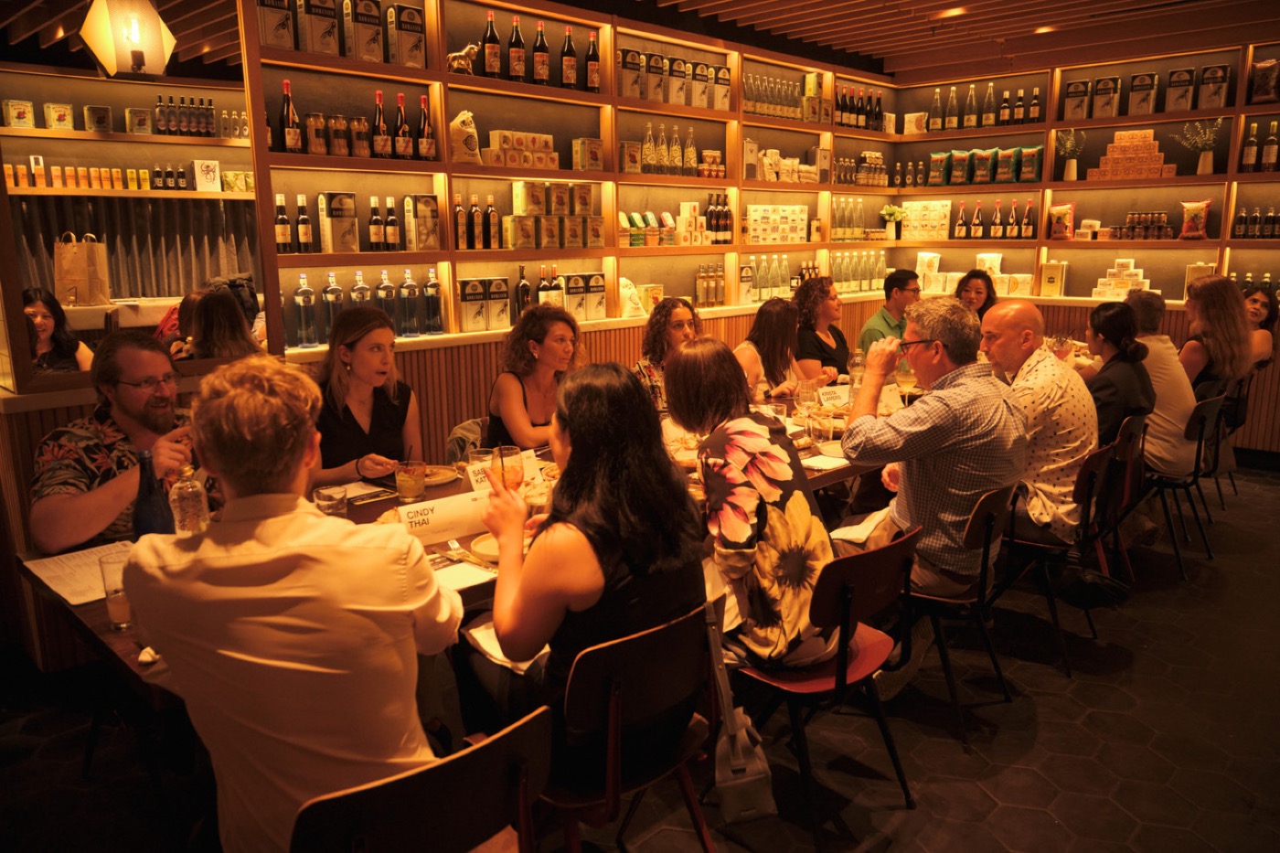 The length of the table, mid-conversation